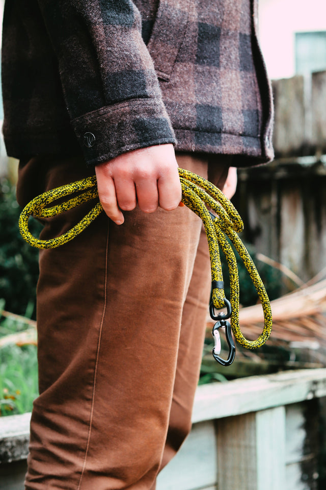 A man holding a rope leash in his hand - guide to choosing the right dog leash length for everyday walks.